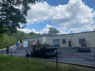 crew-laying-asphalt-on-factory-parking-lot
