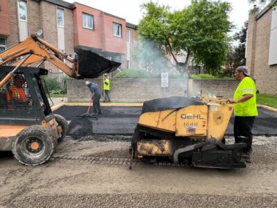 workesr-laying-asphalt-on-driveway
